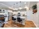 Modern kitchen with white cabinets, granite countertops, stainless steel appliances, and a large island with bar seating at 1313 Haywood Park Rd, Marvin, NC 28173