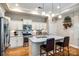 A modern kitchen features stainless steel appliances, granite countertops, and a central island with seating at 1313 Haywood Park Rd, Marvin, NC 28173