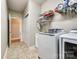 Well-equipped laundry room with modern washer and dryer, sink, and ample storage shelves at 1313 Haywood Park Rd, Marvin, NC 28173