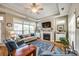 Cozy living room with fireplace, tray ceiling, hardwood floors, and large windows for ample natural light at 1313 Haywood Park Rd, Marvin, NC 28173
