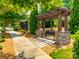 Outdoor seating in a park-like setting with stone benches, pergola and landscaped surroundings at 1313 Haywood Park Rd, Marvin, NC 28173