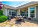 This outdoor living space offers a stone patio with dining and seating areas, a grill, and lush landscaping at 1313 Haywood Park Rd, Marvin, NC 28173