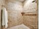 The tiled shower showcases neutral color and patterns with a built-in niche and chrome hardware at 1313 Haywood Park Rd, Marvin, NC 28173
