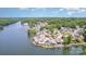 A picturesque aerial view reveals lakeside living with lush trees, a marina, and charming waterfront houses at 141 Badin Lake Cir, New London, NC 28127