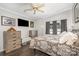 Cozy bedroom with ceiling fan, mounted TV, and dark wood flooring at 141 Badin Lake Cir, New London, NC 28127