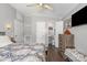Inviting bedroom with mounted TV, ensuite bathroom, and dark wood flooring at 141 Badin Lake Cir, New London, NC 28127