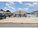 Attractive single-story home with a spacious front yard, ample parking, and a hint of the lake in the background at 141 Badin Lake Cir, New London, NC 28127