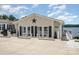 Inviting home with a charming facade, featuring a front porch with chairs and lake views beyond the property at 141 Badin Lake Cir, New London, NC 28127
