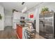 Well-lit kitchen features white cabinets, stainless appliances, granite countertops, and a stylish red kitchen island at 141 Badin Lake Cir, New London, NC 28127