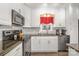 Up-close view of kitchen featuring stainless steel appliances, granite countertops, subway tile backsplash, and white cabinetry at 141 Badin Lake Cir, New London, NC 28127