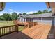 Spacious outdoor deck overlooks the backyard with lush lawn and beautiful landscaping at 15020 Ranson Rd, Huntersville, NC 28078