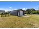 Large metal barn with a white door and concrete pad, surrounded by a green pasture at 15020 Ranson Rd, Huntersville, NC 28078