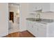 Bathroom vanity with granite countertops and white cabinets, next to the doorway to a sauna at 15020 Ranson Rd, Huntersville, NC 28078