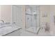Bathroom with glass shower, neutral tile, a marble countertop vanity and decorative accent at 15020 Ranson Rd, Huntersville, NC 28078