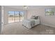 Bright bedroom features a ceiling fan and a sliding glass door to the outdoor deck at 15020 Ranson Rd, Huntersville, NC 28078