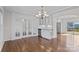 Dining room with hardwood floors, chandelier, and glass paneled doors leading to another room at 15020 Ranson Rd, Huntersville, NC 28078