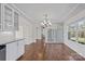Dining room with hardwood floors, a chandelier and a window overlooking the yard at 15020 Ranson Rd, Huntersville, NC 28078
