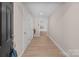 Inviting foyer with light wood flooring, neutral walls, and white trim leading to the kitchen at 15020 Ranson Rd, Huntersville, NC 28078