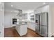 Bright kitchen with stainless steel appliances, white cabinets, granite countertops and a kitchen island at 15020 Ranson Rd, Huntersville, NC 28078