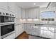 Kitchen features stainless appliances, granite counters, white cabinets, tile backsplash, and a window view at 15020 Ranson Rd, Huntersville, NC 28078