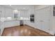 Bright kitchen with stainless steel appliances, granite counters, white cabinets and hardwood flooring at 15020 Ranson Rd, Huntersville, NC 28078