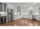 Spacious kitchen featuring white cabinets, stainless steel appliances, and hardwood flooring at 15020 Ranson Rd, Huntersville, NC 28078