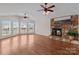 Living room with hardwood floors, a stone fireplace, lots of natural light and vaulted ceilings at 15020 Ranson Rd, Huntersville, NC 28078