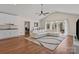 Bright living room with vaulted ceilings, hardwood floors, a white sofa, and natural light at 15020 Ranson Rd, Huntersville, NC 28078