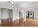 Open concept living room with hardwood floors, white columns and trim, arched entryways and lots of natural light at 15020 Ranson Rd, Huntersville, NC 28078