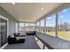 Relaxing sunroom featuring comfortable seating, screens all around, and serene views of the surrounding landscape at 15020 Ranson Rd, Huntersville, NC 28078