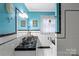 Well-lit bathroom features a double sink vanity, blue walls, and black and white tile at 151 Cynthia St, Statesville, NC 28677
