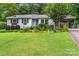 Beautiful lawn and charming home exterior with luscious landscaping at 151 Cynthia St, Statesville, NC 28677