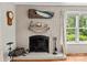 Close-up of the brick fireplace with decorative mantel and hearth, accented by wood floors at 151 Cynthia St, Statesville, NC 28677