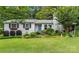 Charming cottage-style home with brick facade, colorful landscaping, and inviting front yard at 151 Cynthia St, Statesville, NC 28677