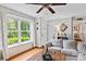 Sun-filled living area with wood floors, white brick accent wall, and large window at 151 Cynthia St, Statesville, NC 28677
