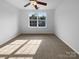 Sunlit bedroom with large window and neutral carpet at 1573 Maypine Commons Way, Rock Hill, SC 29732