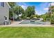 Lush backyard with pool, waterfall feature, and manicured lawn at 1619 Providence Rd, Charlotte, NC 28207