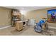 Finished basement featuring tile floors, desk area, musical instruments, and colorful artwork at 1619 Providence Rd, Charlotte, NC 28207