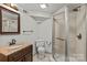 Bathroom with a glass shower, vanity with marble countertop and decorative mirror at 1619 Providence Rd, Charlotte, NC 28207