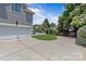 Long driveway with an attached garage and a landscaped lawn with pool and basketball court beyond at 1619 Providence Rd, Charlotte, NC 28207
