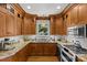 Well-equipped kitchen featuring wooden cabinets, stainless steel appliances, granite countertops, and hardwood flooring at 1619 Providence Rd, Charlotte, NC 28207