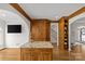 Open kitchen showcasing hardwood floors, custom wood cabinets, a granite island, and ample storage space at 1619 Providence Rd, Charlotte, NC 28207