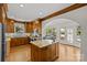 Spacious kitchen with wood cabinets, stainless steel appliances, granite counters, and a breakfast nook with large windows at 1619 Providence Rd, Charlotte, NC 28207