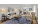 Spacious living room with a comfortable couch, a leather ottoman, and stylish artwork at 1619 Providence Rd, Charlotte, NC 28207