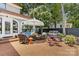 Brick patio with umbrella-covered dining area and outdoor kitchen at 1619 Providence Rd, Charlotte, NC 28207