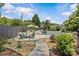 Backyard pool area with lounge chairs, a waterfall feature, and lovely landscaping at 1619 Providence Rd, Charlotte, NC 28207