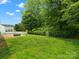 The backyard features lush green grass, partial fencing, and a private patio with a firepit at 1660 Beleek Ridge Ln, Lake Wylie, SC 29710