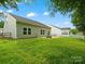 The backyard offers lush green grass, partial fencing, and a private patio with a firepit at 1660 Beleek Ridge Ln, Lake Wylie, SC 29710