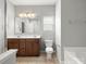 Well-lit bathroom featuring a double vanity, toilet, and a bathtub at 1660 Beleek Ridge Ln, Lake Wylie, SC 29710