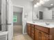Bright bathroom with double vanity sinks and a view into the bedroom at 1660 Beleek Ridge Ln, Lake Wylie, SC 29710